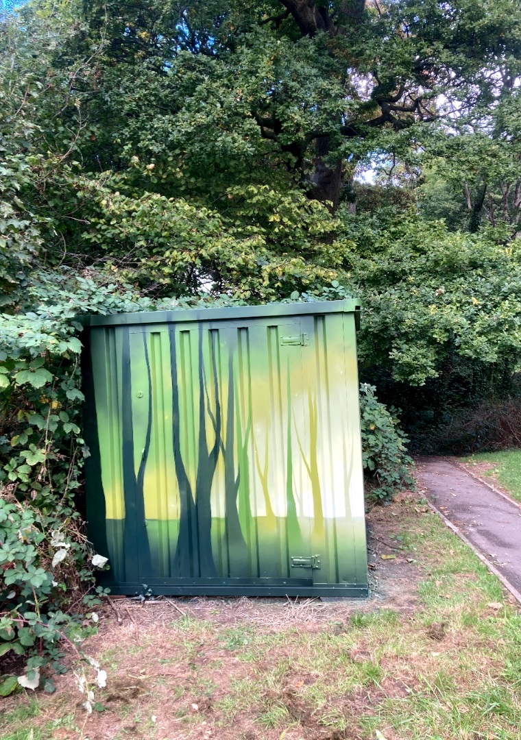 Small woodland green shipping container