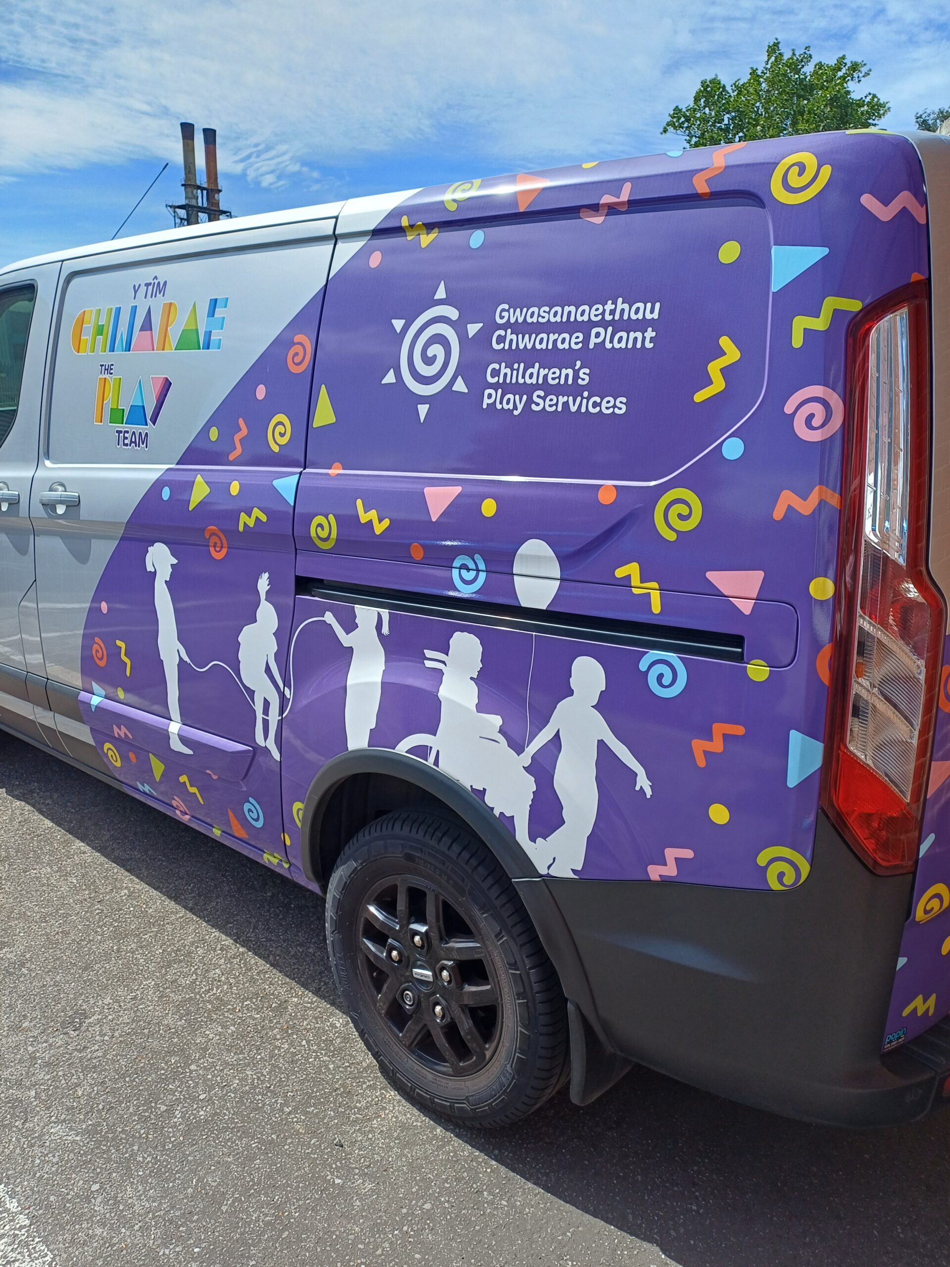 Silver and Purple Van with silhouette of children playing